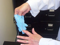 Turn you finger 180 degrees and pull the glove outwards and towards your finger tips
