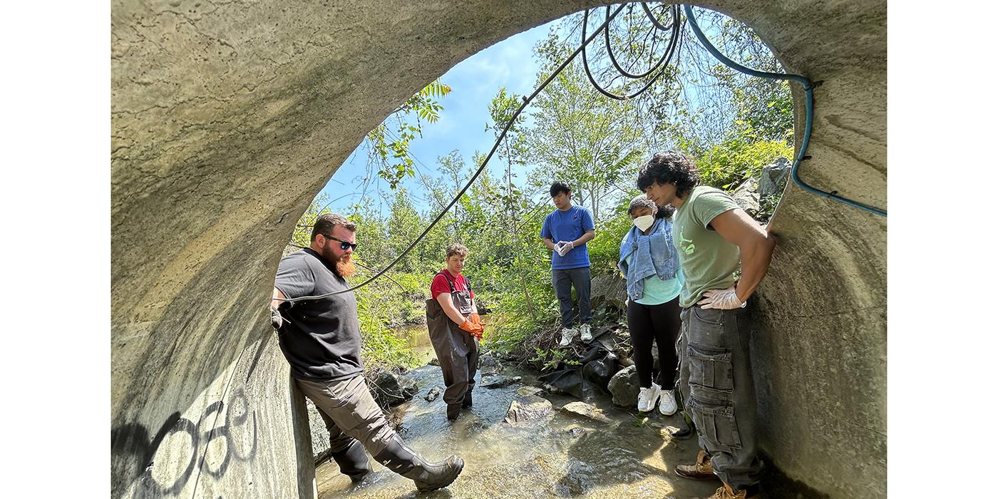 Environmental Affair Staff working on collecting storm water samples